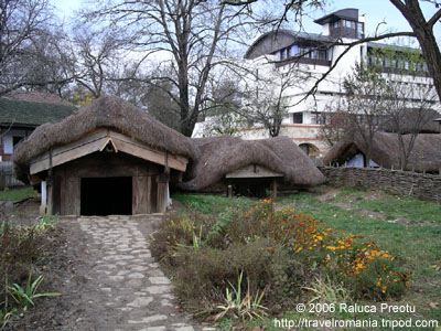Old partially buried huts and contemporary architecture